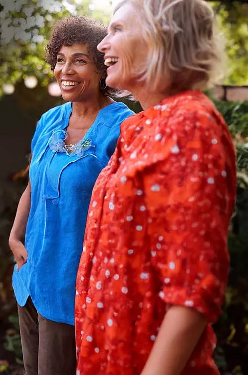 Retirement-aged women standing in garden