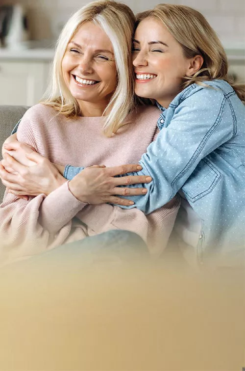 Mother and daughter sitting on couch