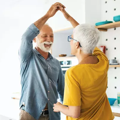 older couple dancing in the kitchen